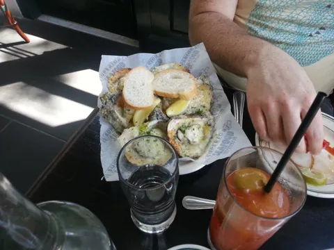 Jake got 6 char grilled oysters smothered in cheese and herbs